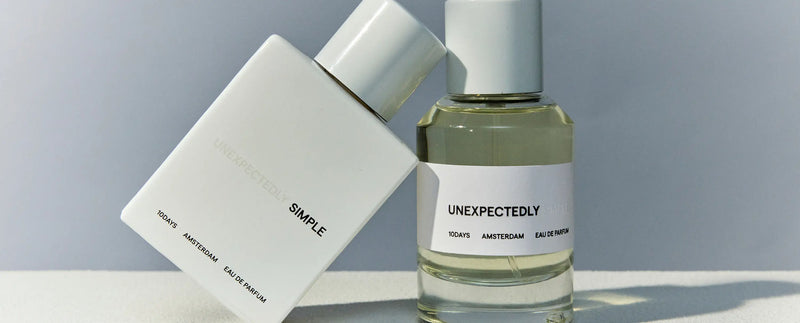 Two perfume bottles with labels 'Simple' and 'Unexpectedly' on a light gray background