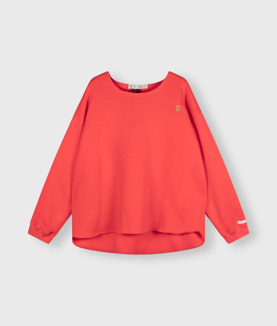 raw edge statement sweater | coral red